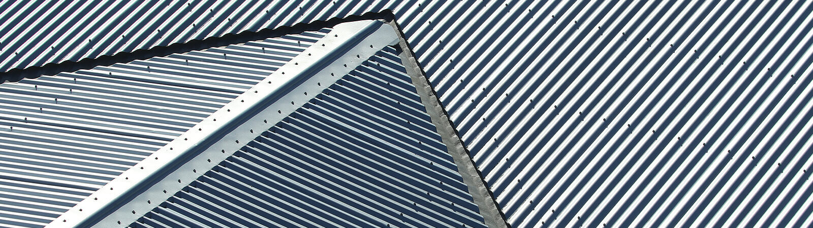 Close up of metal roof sections joining in centre