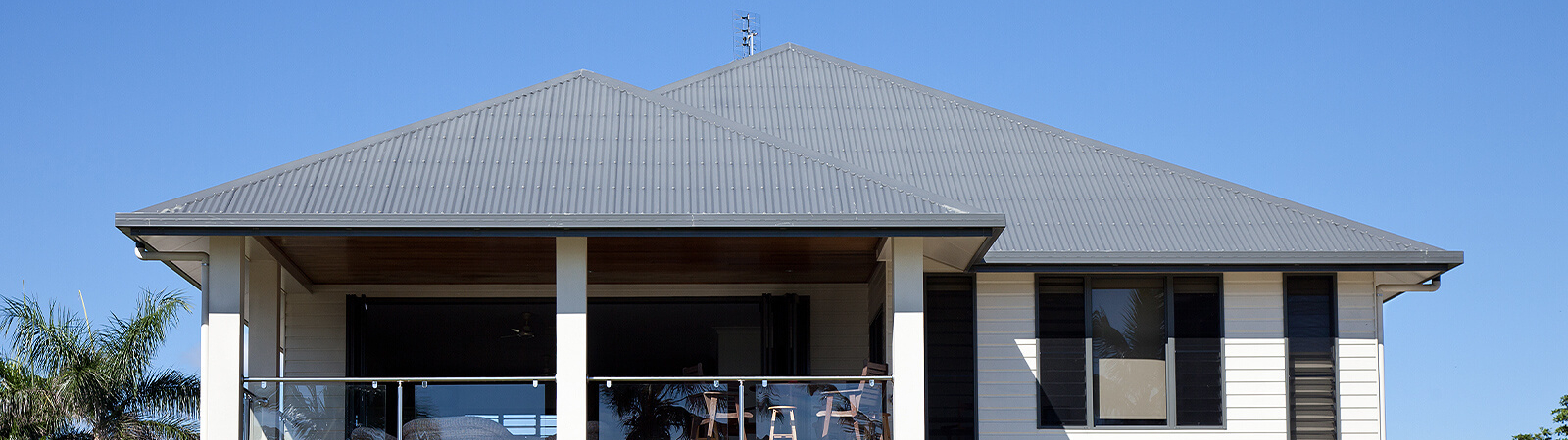 Beachside house and blue sky & trees in background